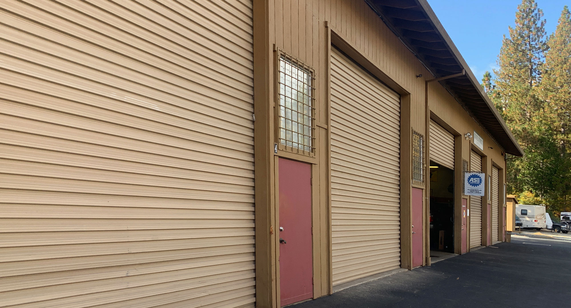 Light Industrial Spaces for Rent building, tan building with metal rollup doors